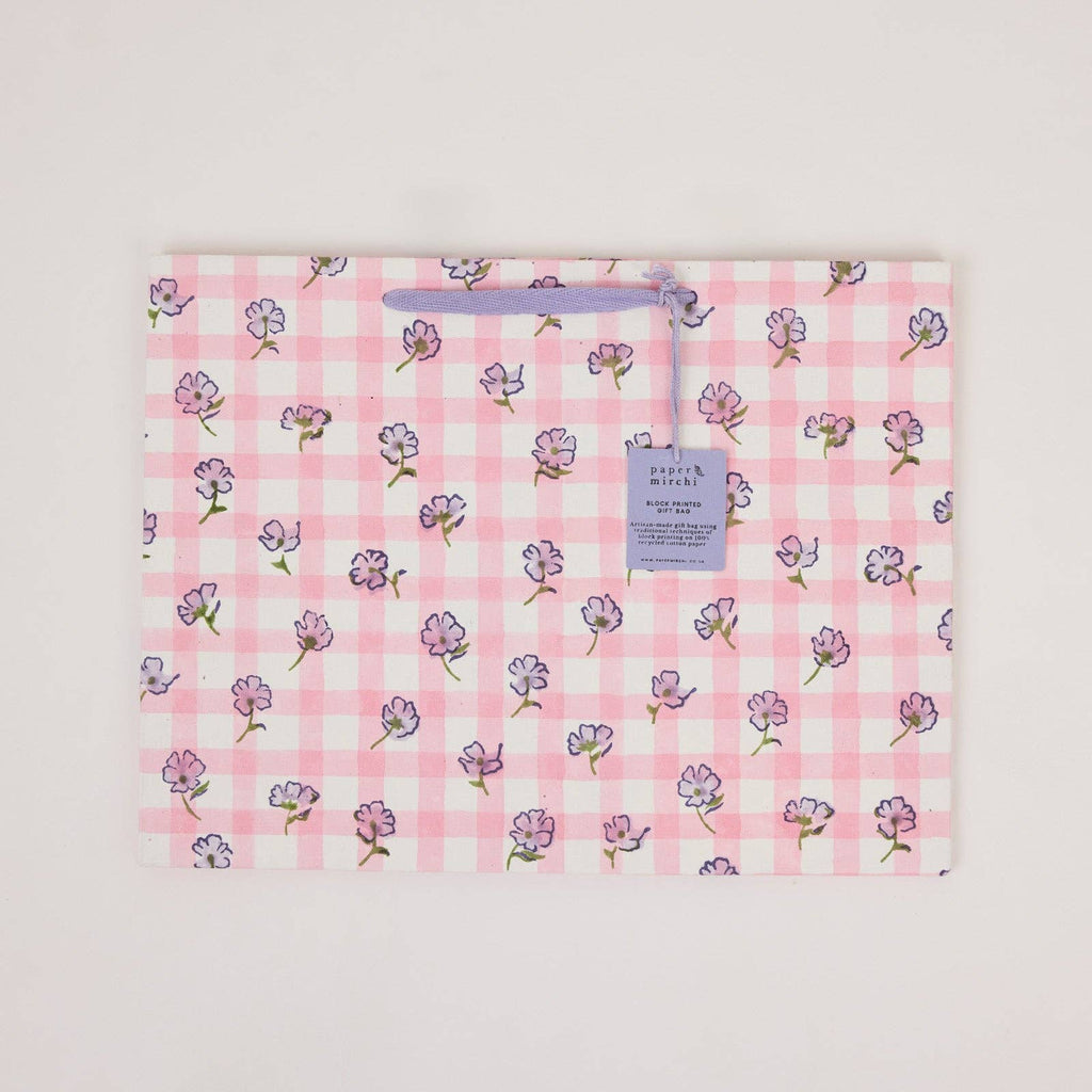 Floral-patterned fabric with a tag on a light gray background