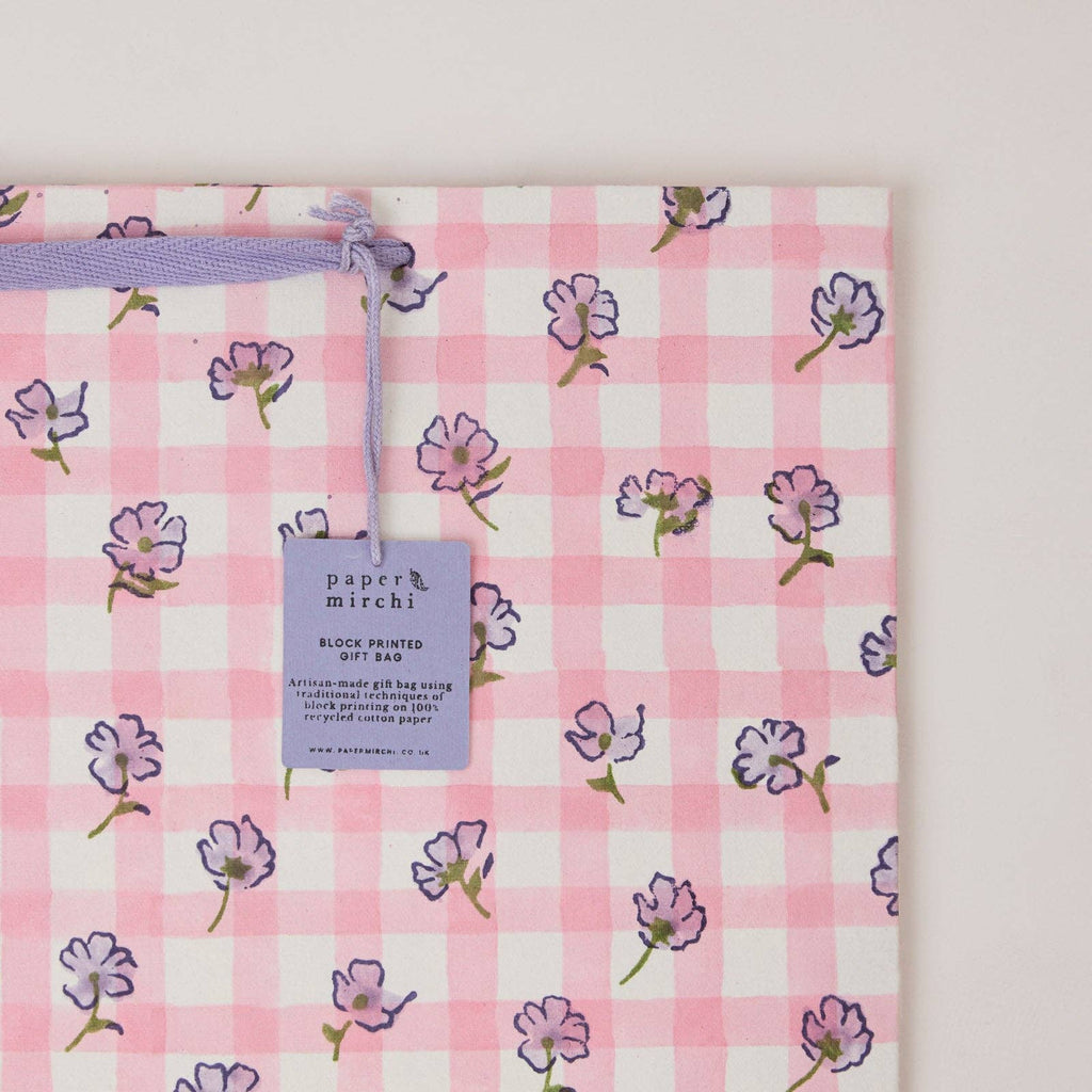 Pink checkered fabric with floral patterns and a 'paper mirchi' tag.