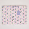 Floral-patterned blanket with a brand label on a light gray background