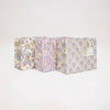 Three patterned boxes stacked on a light gray background