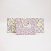 Set of three floral-patterned boxes on a light gray background