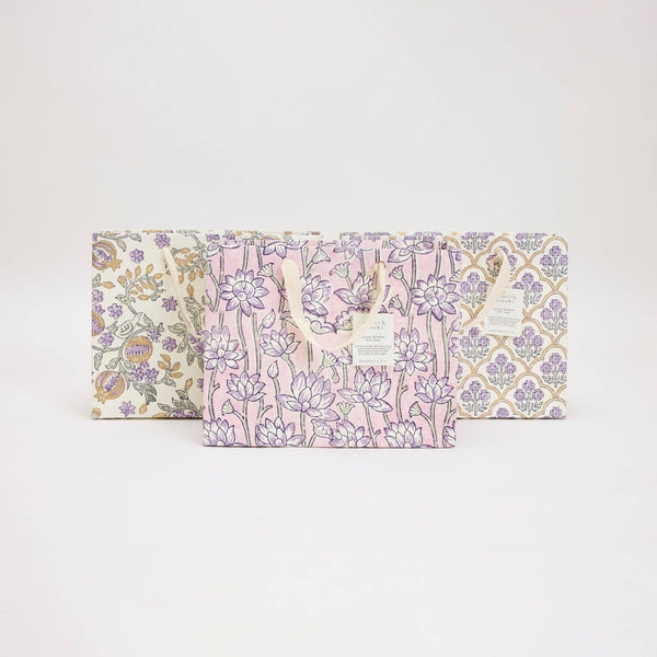 Set of three floral-patterned boxes on a light gray background