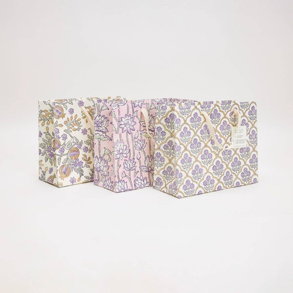 Three patterned boxes stacked on a light gray background