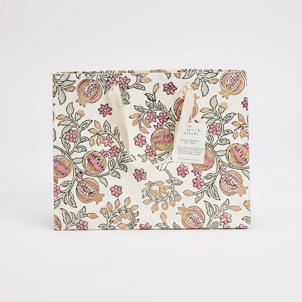Floral and pomegranate patterned fabric on a white background