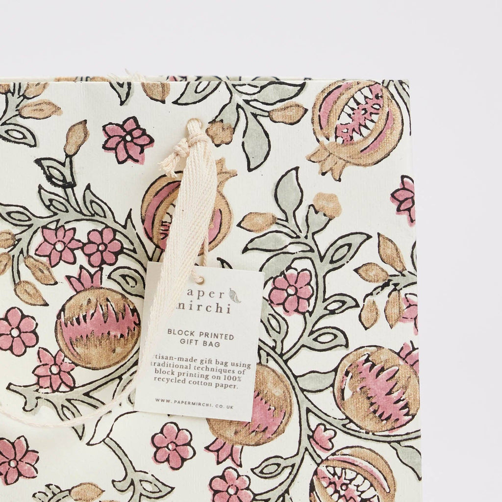 Floral patterned gift bag with a visible brand tag on a white background