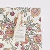 Floral patterned gift bag with a visible brand tag on a white background