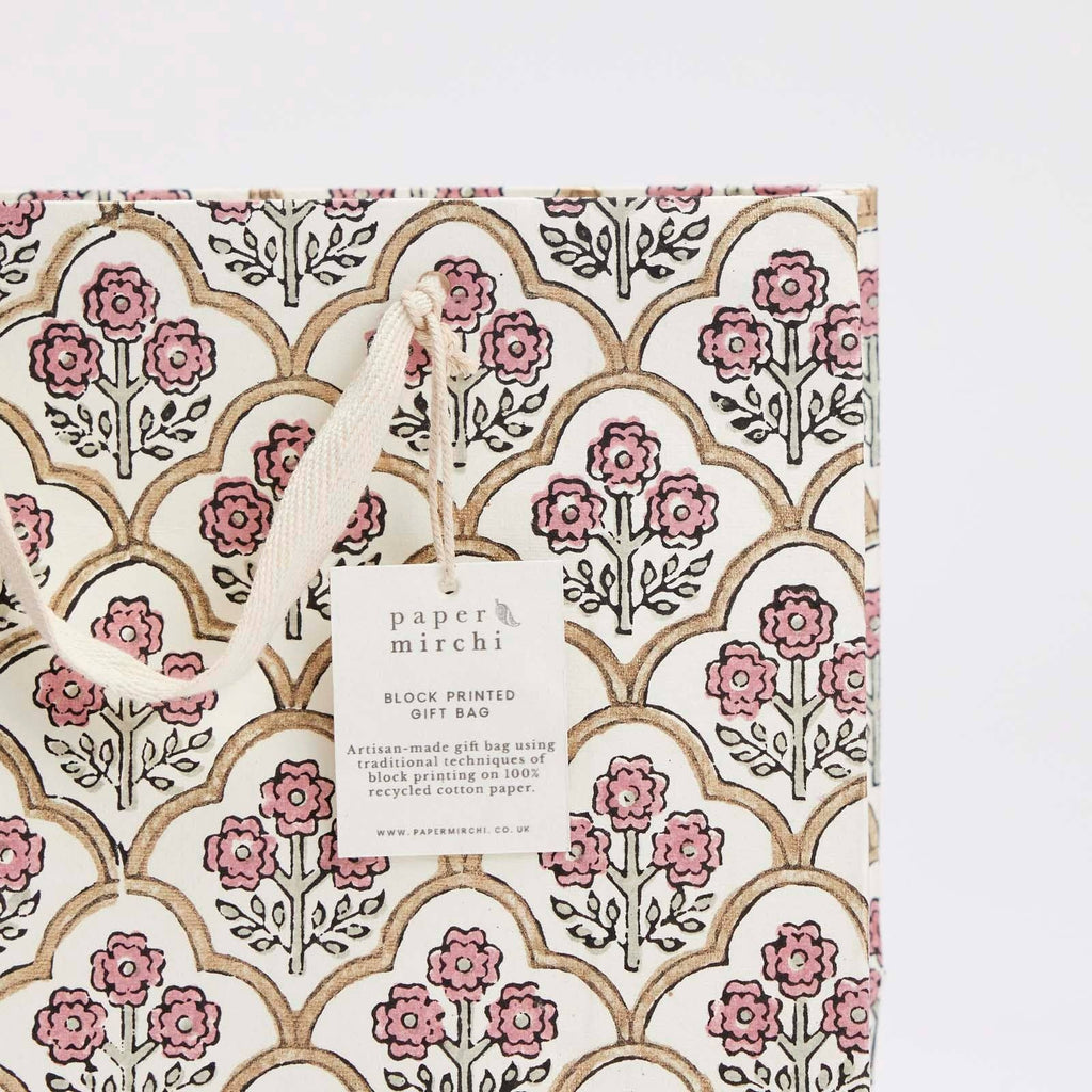 Floral patterned gift bag with 'paper mirchi' tag on a white background