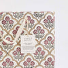 Floral patterned gift bag with 'paper mirchi' tag on a white background
