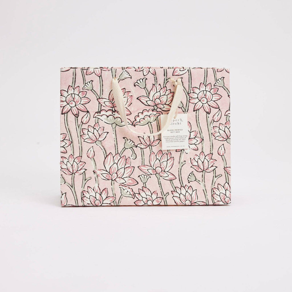 Floral patterned product packaging on a light pink background
