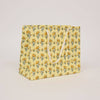Floral-patterned paper bag on a light beige background