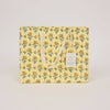 Yellow floral-patterned tote bag on a light gray background