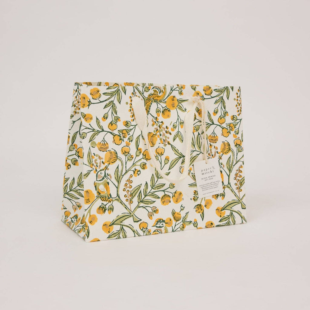 Floral-patterned bag with a visible brand tag on a light gray background