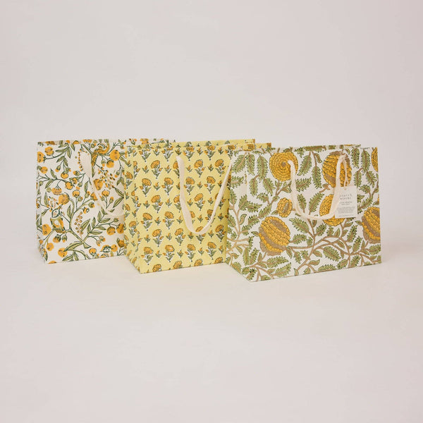 Set of three fabric bags with floral patterns on a light gray background