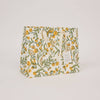 Floral-patterned bag with a visible brand tag on a light gray background
