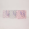 Two pink bags with floral and checkered patterns on a light gray background