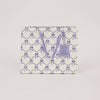 Gift bag with purple bow pattern on a white background