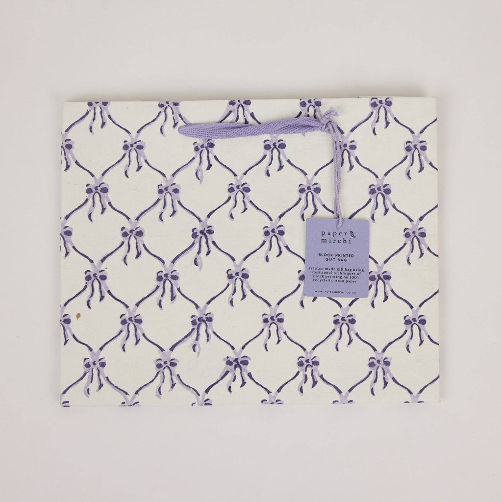 Packaged product with purple bow pattern and 'Papers & Mirrors' tag on a white background