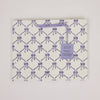 Packaged product with purple bow pattern and 'Papers & Mirrors' tag on a white background