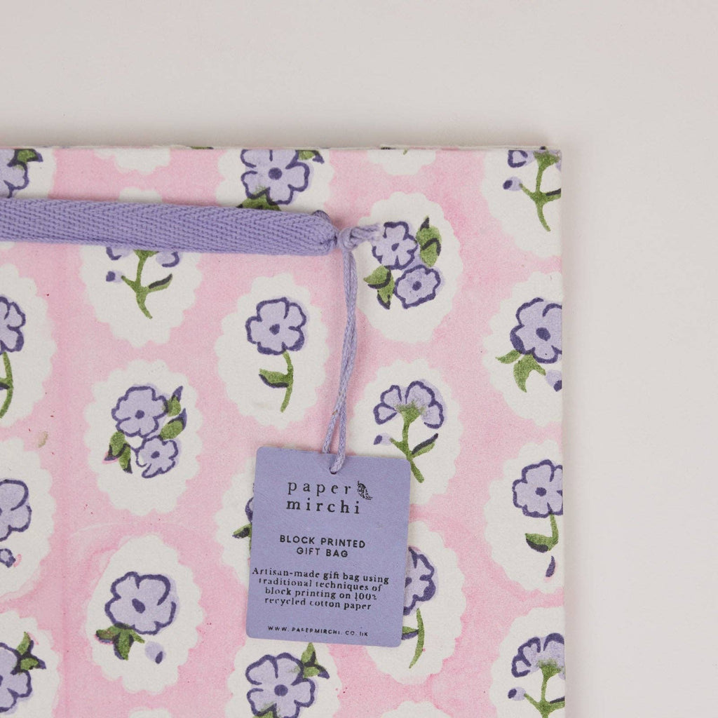 Floral-patterned gift bag with a 'paper mirchi' tag on a white background