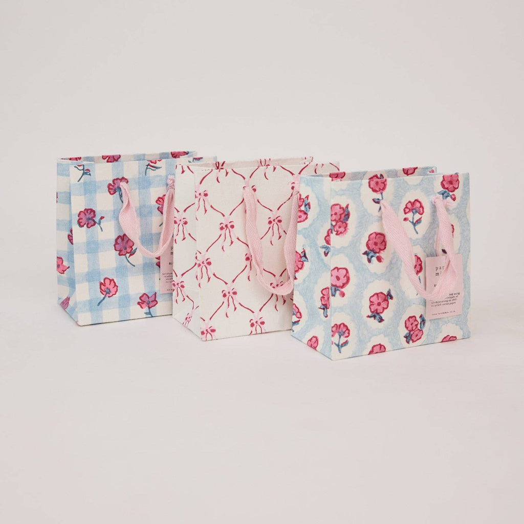 Three patterned bags on a light gray background