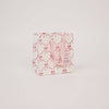 Packaged product with pink bows on a light gray background