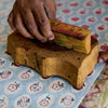 Hand using a wooden block on a patterned surface