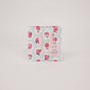 Floral patterned gift bag with pink handle on a light gray background