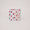 Floral-patterned bag with pink handles on a light gray background
