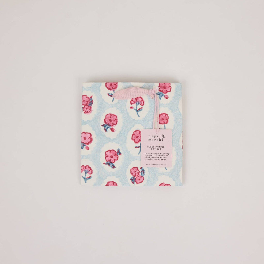Floral patterned product packaging on a light gray background