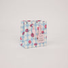 Small gift bag with floral and checkered pattern on a light gray background