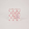 Pink gift bag with bow pattern on a light gray background
