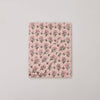 Floral patterned notebook on a light gray background
