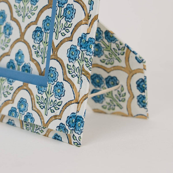 Floral patterned paper with blue flowers on a white background