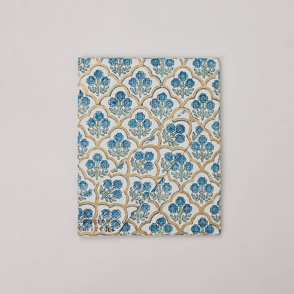 Fabric swatch with blue floral pattern on a beige background