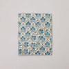 Fabric swatch with blue floral pattern on a beige background