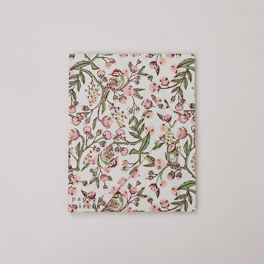 Floral patterned notebook on a light gray background