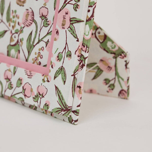 Floral-patterned product with pink accents on a white background