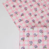Two pink checkered fabrics with floral patterns on a white background