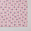 Pink checkered fabric with small floral patterns on a white background