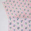 Fabric with purple floral pattern on pink background
