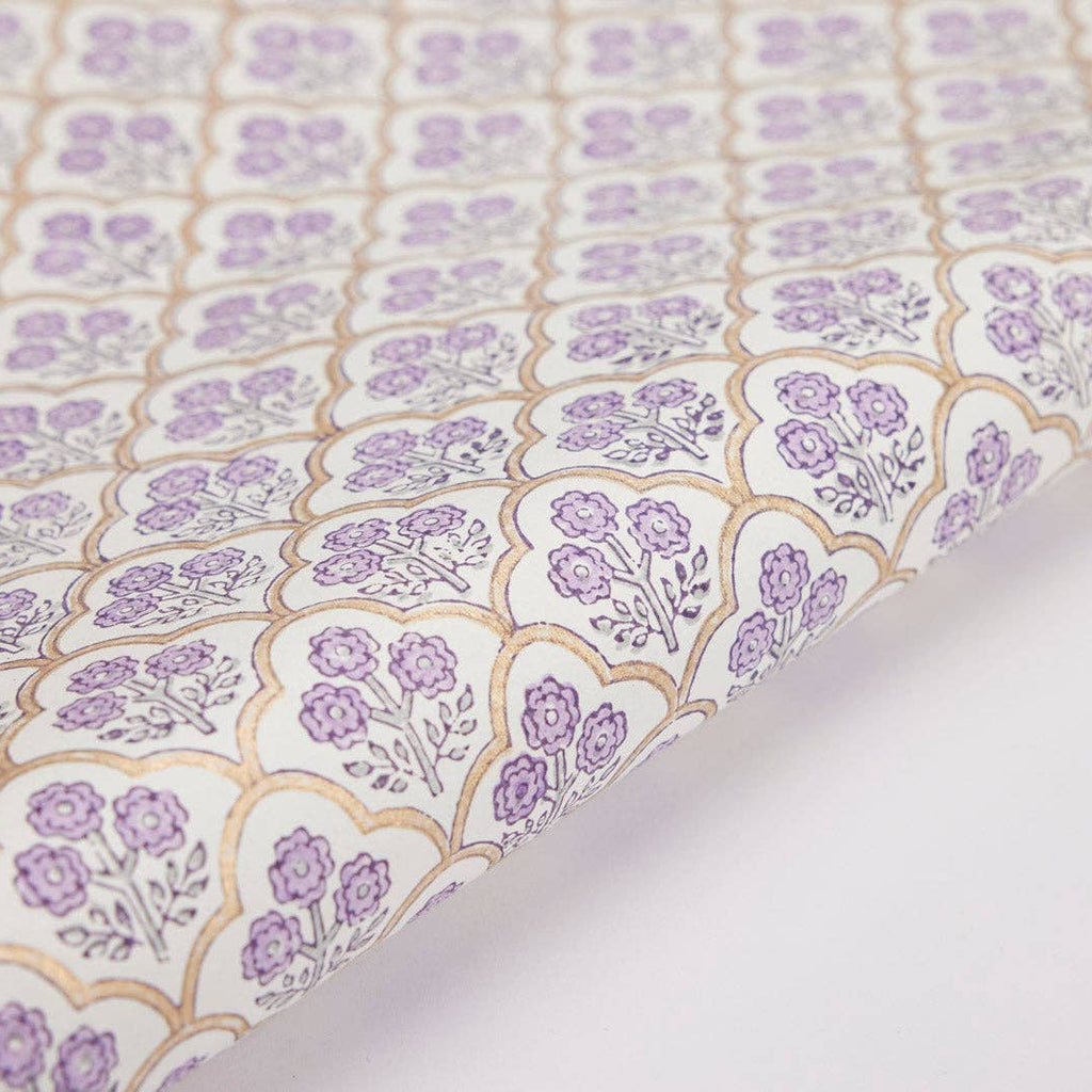 Close-up of floral patterned fabric with purple flowers on a light background