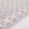 Close-up of floral patterned fabric with purple flowers on a light background