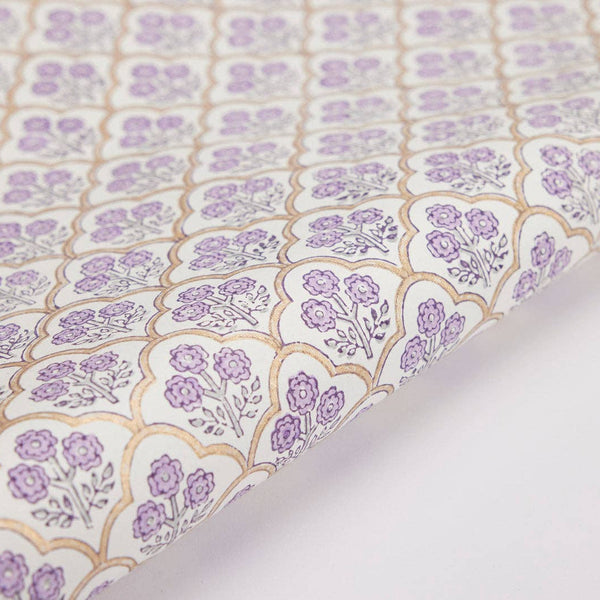 Close-up of floral patterned fabric with purple flowers on a light background