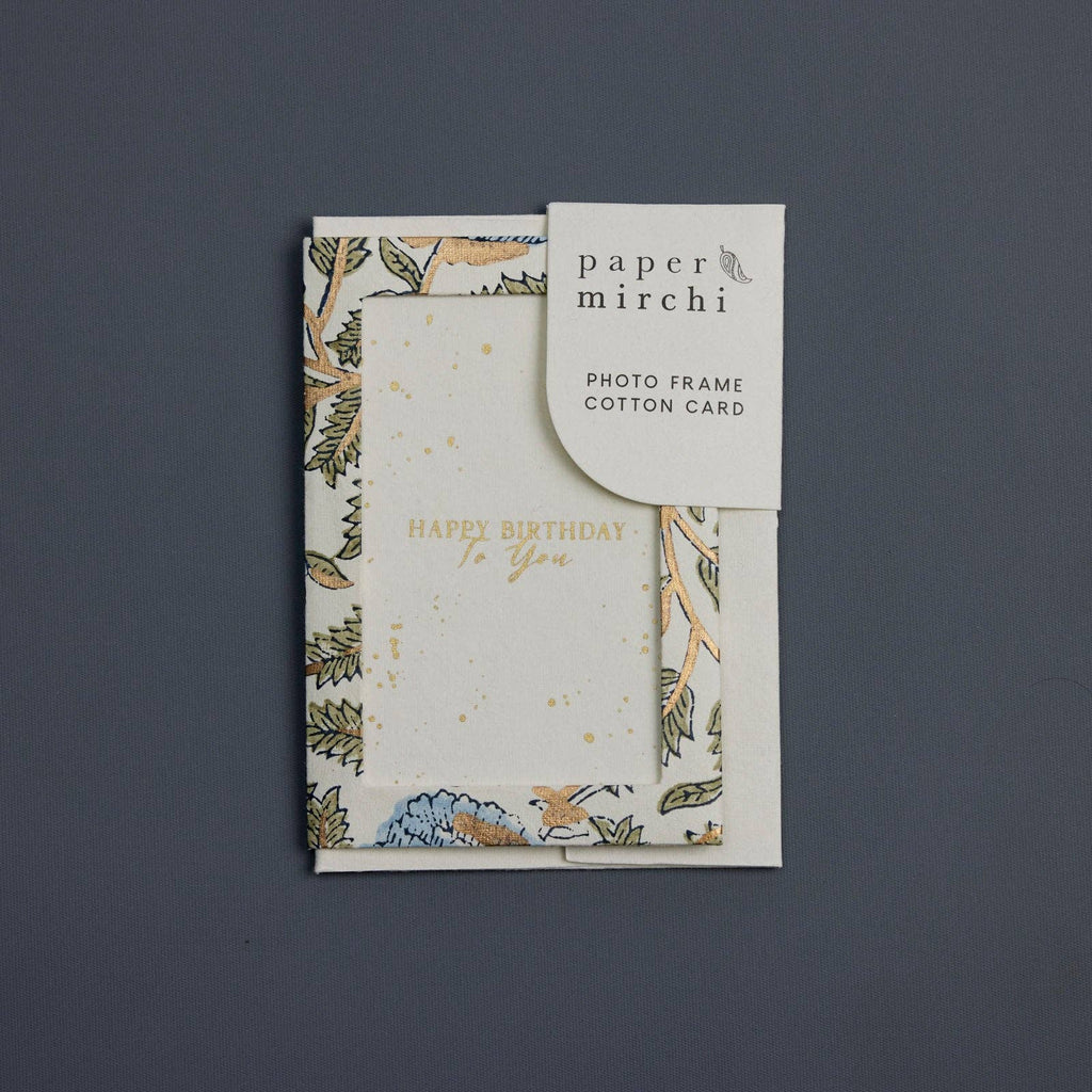 Card with floral design and 'Happy Birthday' text on a dark gray background, branded 'paper mirchi'.