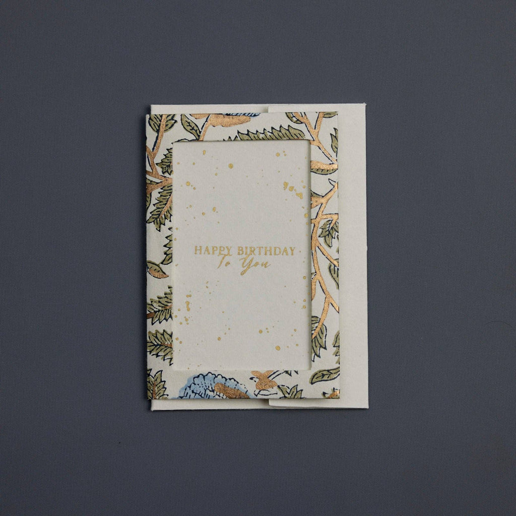 Greeting card with floral design and 'Happy Birthday To You' text on a dark gray background
