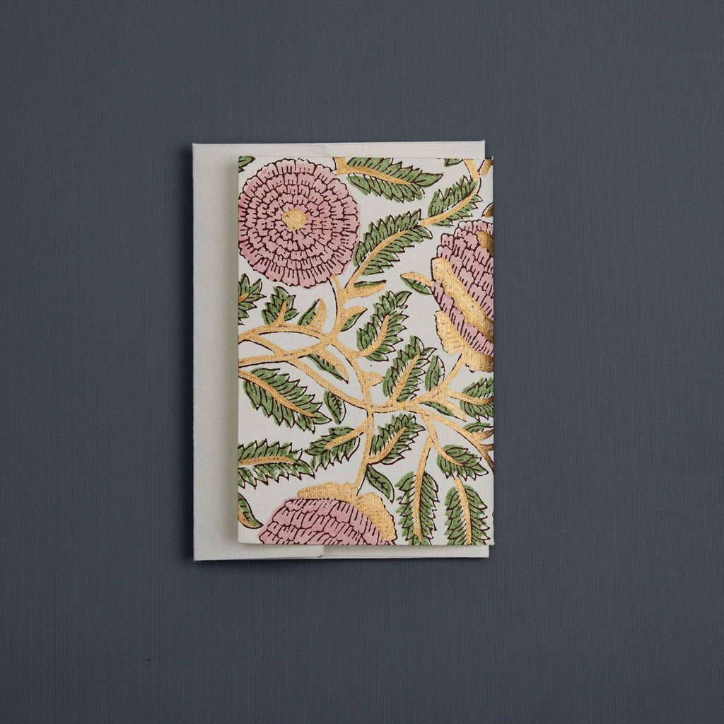 Floral and leaf patterned card on a dark gray background