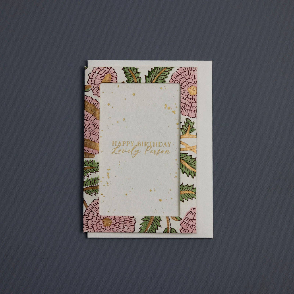 Greeting card with floral design and 'Happy Birthday, Lovely Person' text on a dark background