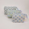 Three fabric pouches with floral patterns on a light gray background