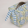 Hexagonal fabric pouch with floral and striped patterns on a light background