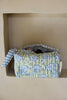 Floral-patterned fabric roll with blue and white stripes on a beige background